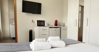 a bedroom with a bed with towels on it at Casa do Recanto - Private Suite in Porto