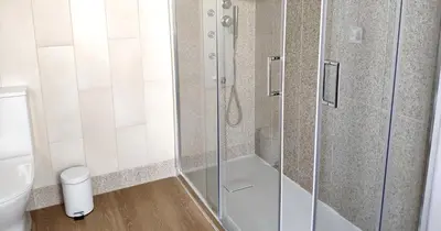 a shower with a glass door in a bathroom at Casa do Recanto - Private Suite in Porto