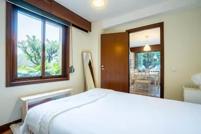 a bedroom with a bed and a large window at Casa Jardim by LovelyStay in Porto