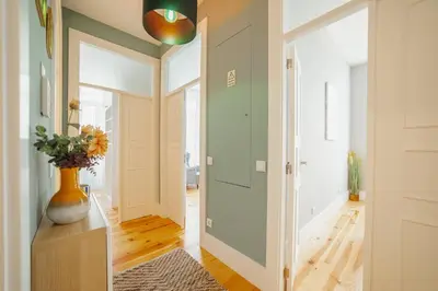 a hallway with a door and a vase on a table at Bonfim Premium by Hosty in Porto