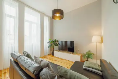 a living room with a couch and a flat screen tv at Bonfim Premium by Hosty in Porto