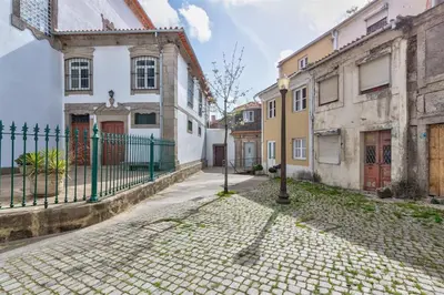 a cobblestone street in an old town with buildings at Cais das Pedras Terrace by Cozy Stay in Porto