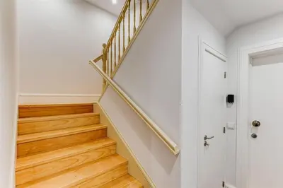 a staircase in a home with white walls and wooden floors at Cais das Pedras Duplex by Cozy Stay in Porto