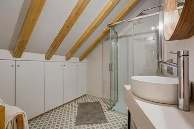 a bathroom with a tub and a glass shower at Cais das Pedras Duplex by Cozy Stay in Porto