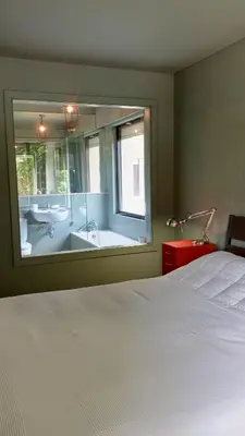 a bedroom with a bed and a bathroom with a tub at Praceta in Porto