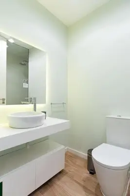 a white bathroom with a toilet and a sink at Lu's Douro View Apartment in Vila Nova de Gaia