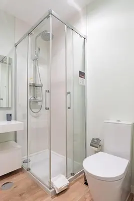 a bathroom with a shower and a toilet at Lu's Douro View Apartment in Vila Nova de Gaia
