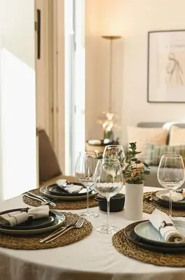 a table with two plates and wine glasses on it at Douro Premium Garden by MP in Vila Nova de Gaia