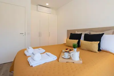 a room with a bed with towels and a tray of food at Host Wise - Fervença Boutique Palace in Vila Nova de Gaia