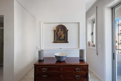 a room with a dresser and a painting on the wall at The Plaza Boavista in Porto