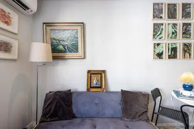 a living room with a blue couch and a table at The Plaza Boavista in Porto
