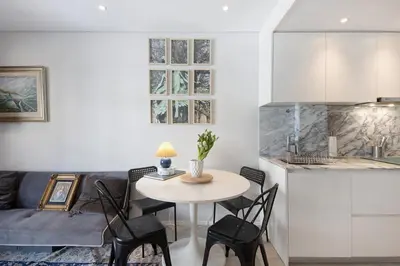 a kitchen and living room with a table and chairs at The Plaza Boavista in Porto