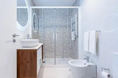 a bathroom with a shower and a sink and a toilet at Cedofeita Sunny Apartment - Balcony & Parking in Porto