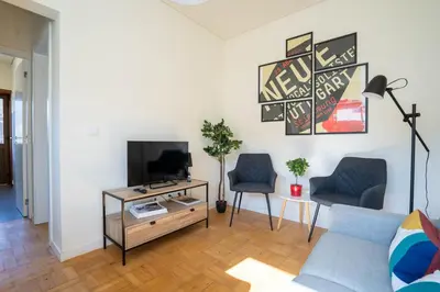 a living room with a blue couch and a tv at Porto Heights by LovelyStay in Porto