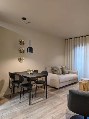 a living room with a table and a couch at BonJardim Apartment by Nove in Porto