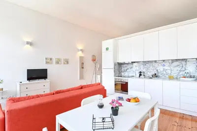 a living room with a red couch and a white table at Oporto Sunset Blue Balcony in Porto