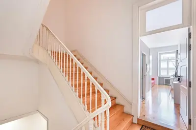 a white staircase in a home with a window at Oporto Sunset Blue Balcony in Porto