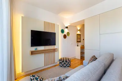 a living room with a couch and a tv at Stylish Poveiros Flat w Balcony by LovelyStay in Porto