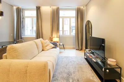 a living room with a brown couch and a chair at Dream Design Flat in Porto