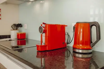 a red appliance sitting on top of a kitchen counter at Rooftop Panoramic Batalha- PORTO in Porto