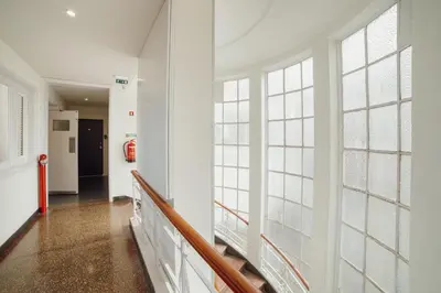 a hallway with large windows in a building at Rooftop Panoramic Batalha- PORTO in Porto