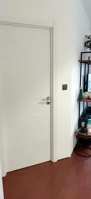 a white door in a room with a wooden floor at Top floor apartment with Sunny Balconies in Porto