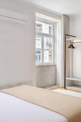 a dining room with tables and chairs and green walls at Rosário Suites Townhouse in Porto