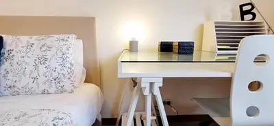 a small bedroom with a bed and a desk at Lovling and Friendly with terrace in Porto