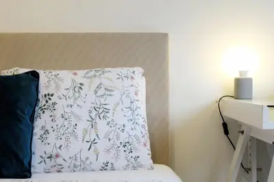a pillow sitting on top of a bed at Lovling and Friendly with terrace in Porto