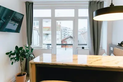 a dining room with a table and a large window at Cedofeita studio 41 in Porto