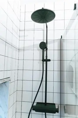 a shower with a hose attached to a wall at Cedofeita studio 41 in Porto