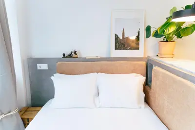 a bed with two pillows on top of it at Cedofeita studio 41 in Porto