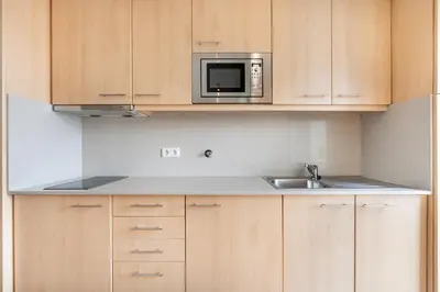 a kitchen with a sink and a microwave at VIVA Stadium Residence Studios in Porto