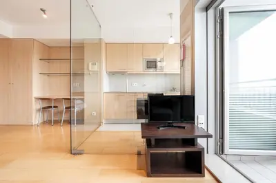 a living room with a television and a table at VIVA Stadium Residence Studios in Porto