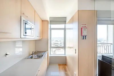 a kitchen with a sink and a window at VIVA Stadium Residence Studios in Porto
