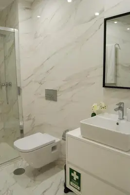 a white bathroom with a toilet and a sink at Almada Prime - Live in Porto in Porto