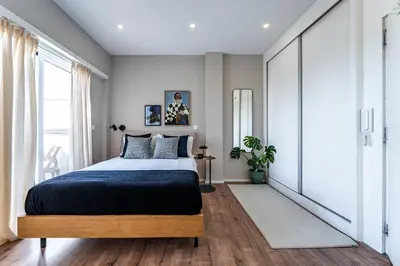 a bedroom with a bed and a large window at Nomad's Easy Stay - Studio Lounge Casa da Musica in Porto