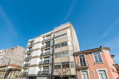 a tall apartment building with a blue sky in the background at Nomad's Easy Stay - Studio Lounge Casa da Musica in Porto