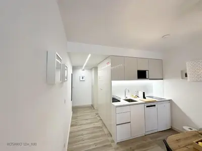 a kitchen with white cabinets and a sink at ROSARIO 1Dn by rosario inn porto in Porto
