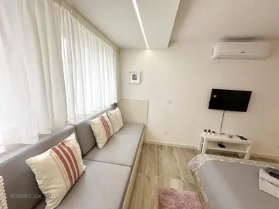 a living room with a couch and a tv at ROSARIO 1Dn by rosario inn porto in Porto