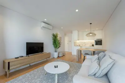 a living room with a couch and a tv at GuestReady - Comfortable stay in Porto in Porto