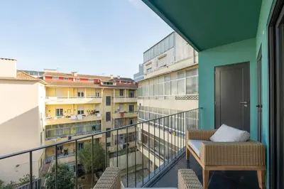 a balcony with a chair and a view of a building at GuestReady - Comfortable stay in Porto in Porto