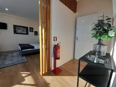 a living room with a fire hydrant and a glass table at Vista Bolhão Studio in Porto