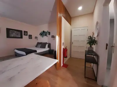 a small living room with a bed and a couch at Vista Bolhão Studio in Porto