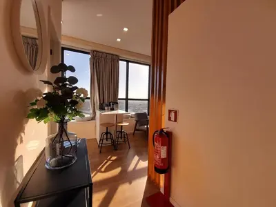 a living room with a vase of flowers on a table at Vista Bolhão Studio in Porto