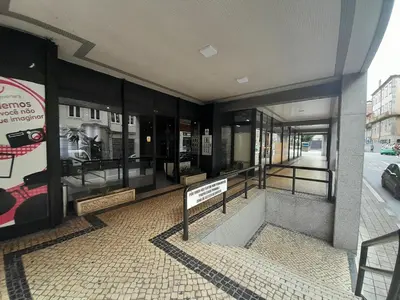 a building with a display of glass windows on a street at VB Porto Studio II in Porto