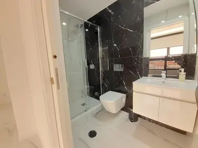 a bathroom with a toilet and a shower and a sink at VB Porto Studio II in Porto