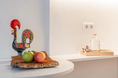 a display of fruit on a table with a bottle of wine at Bandeiras in Porto