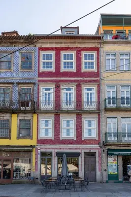 a large red building with tables in front of it at YOUROPO - Torre in Porto