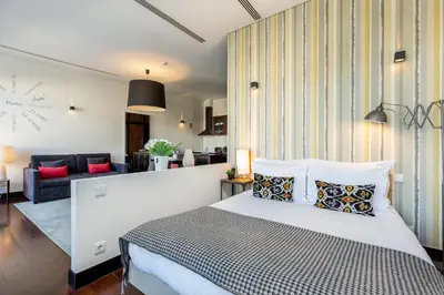 a bedroom with a bed and a living room at YOUROPO - Torre in Porto